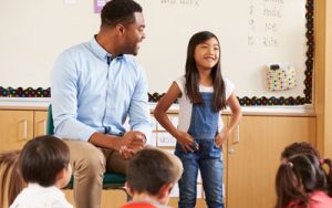 Male teacher at head of class