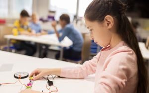 Young girl working on robotics