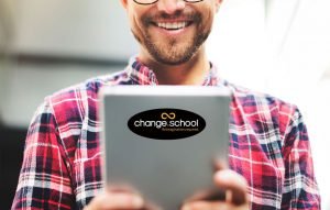 man-holding-tablet-with-change-school-sticker-500px